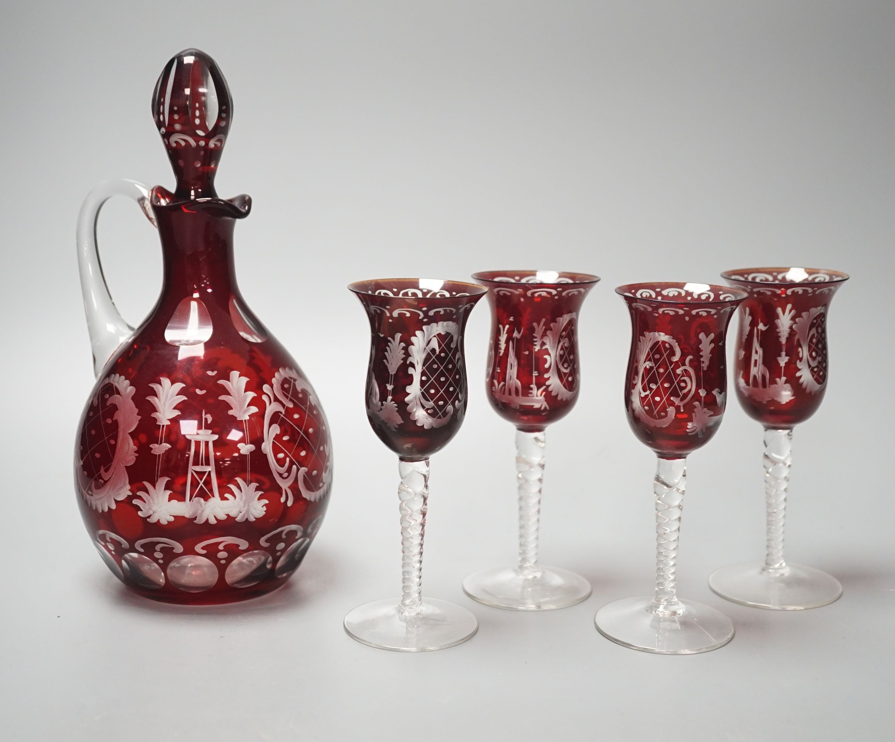 A Bohemian wheel engraved ruby flashed glass decanter and four matching liqueur glasses